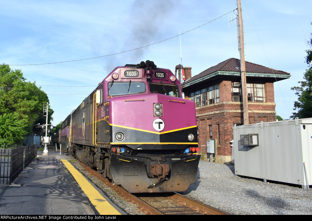 MBTA Train # 498 heads away from Waltham Station, passing the iconic standing but out of service Waltham B&M tower